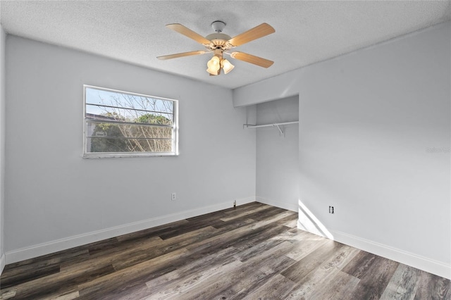 spare room featuring ceiling fan, dark hardwood / wood-style floors, and a textured ceiling