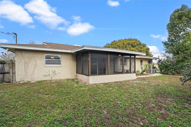 back of house with a sunroom and a yard