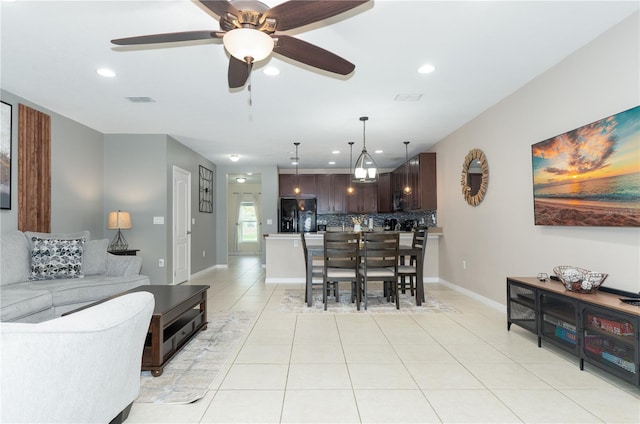 tiled dining area with ceiling fan