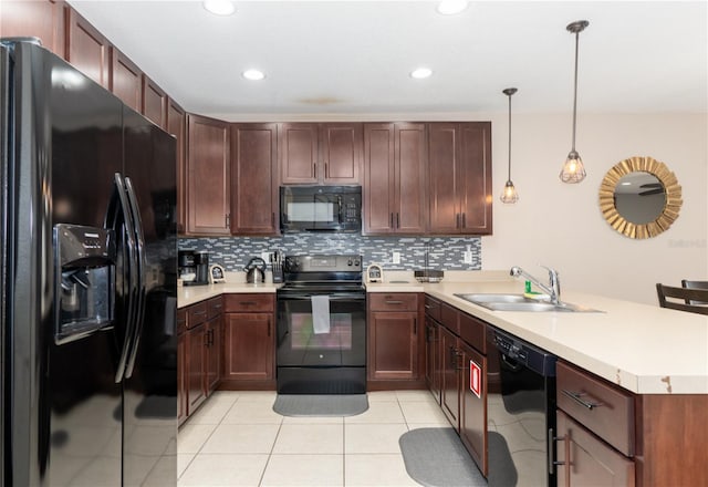 kitchen featuring kitchen peninsula, hanging light fixtures, black appliances, and sink