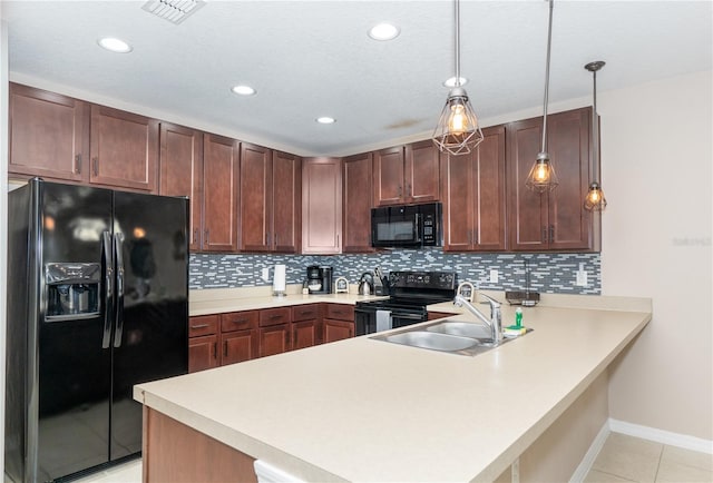 kitchen with kitchen peninsula, sink, black appliances, decorative light fixtures, and light tile patterned flooring