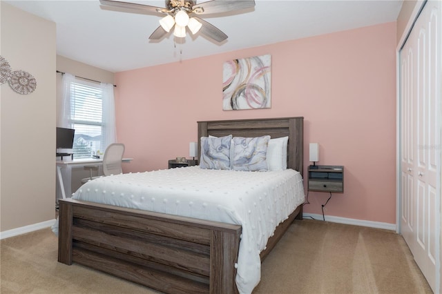 carpeted bedroom with ceiling fan and a closet