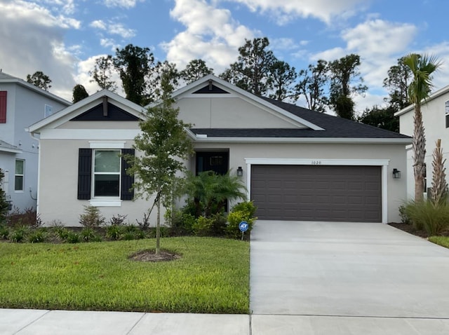 single story home with a front yard and a garage