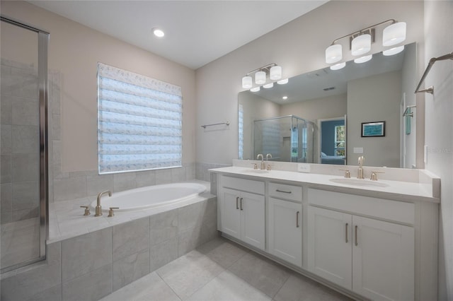 bathroom with tile patterned flooring, vanity, and shower with separate bathtub