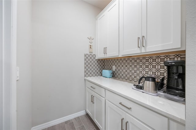 kitchen featuring backsplash and white cabinetry