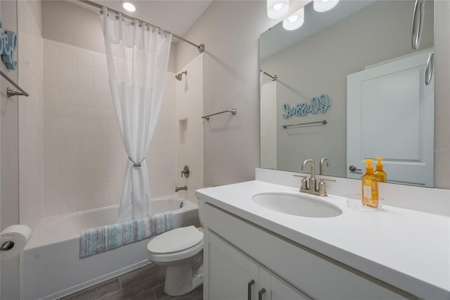 full bathroom with vanity, shower / bath combination with curtain, and toilet