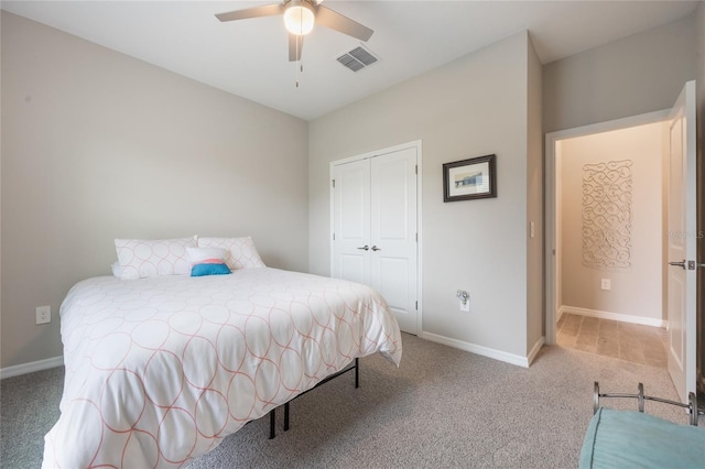 carpeted bedroom with ceiling fan and a closet