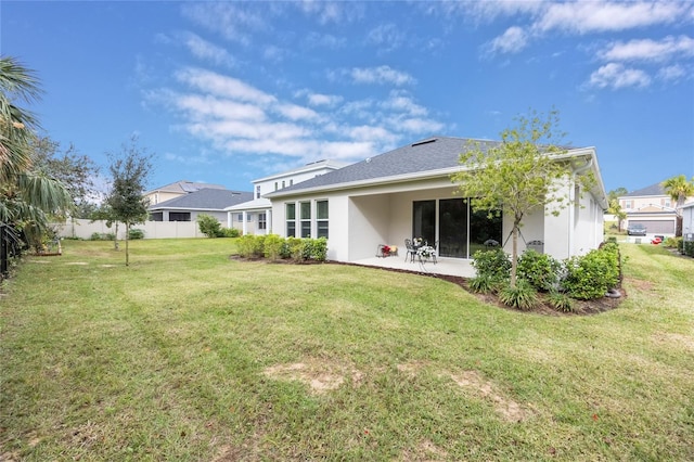 rear view of house with a patio area and a yard