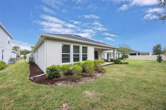 rear view of property with a yard and cooling unit