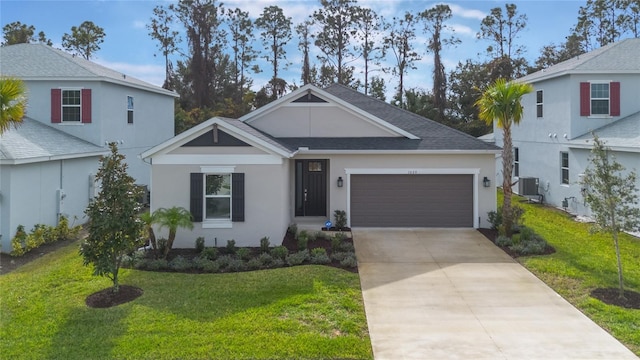 view of front of property with a front lawn, a garage, and central AC unit