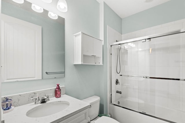 full bathroom featuring vanity, bath / shower combo with glass door, and toilet