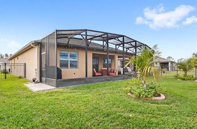 rear view of property featuring a lawn and glass enclosure