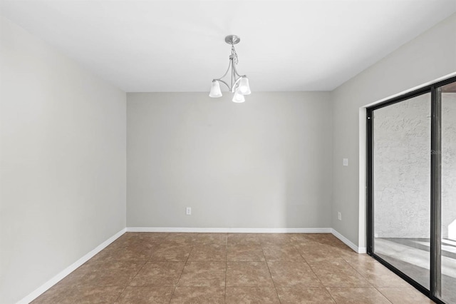 tiled empty room featuring an inviting chandelier