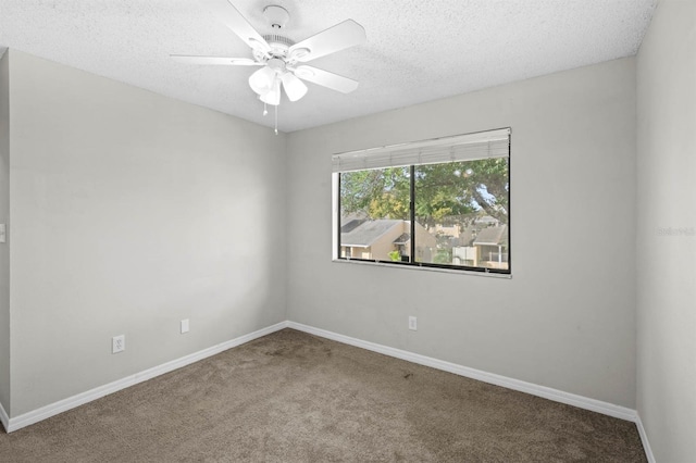 carpeted empty room with ceiling fan and a textured ceiling