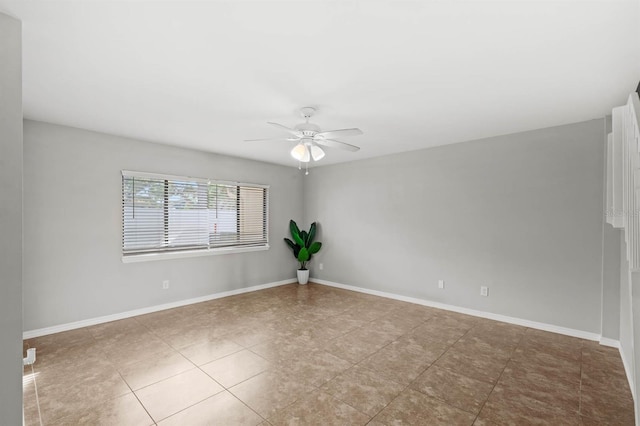 empty room featuring ceiling fan and light tile patterned flooring