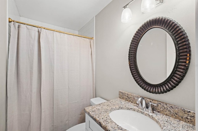 bathroom featuring a shower with curtain, vanity, and toilet