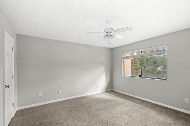 empty room featuring carpet flooring, ceiling fan, and a textured ceiling