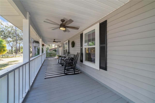 wooden terrace with ceiling fan and a porch