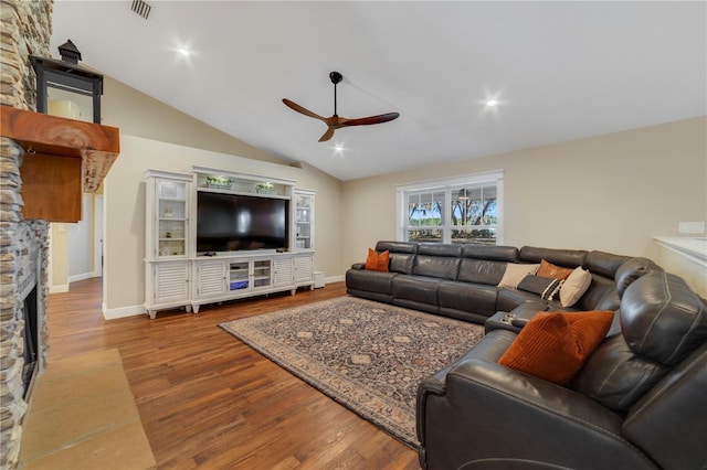 living room with a fireplace, hardwood / wood-style flooring, ceiling fan, and lofted ceiling