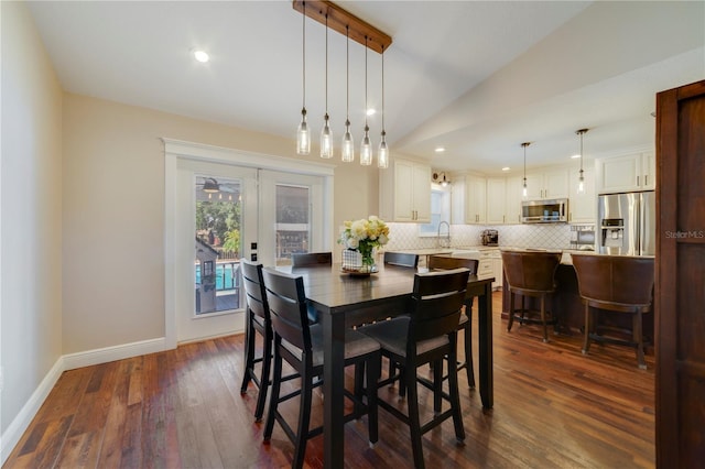 dining area with vaulted ceiling, french doors, dark hardwood / wood-style floors, and sink