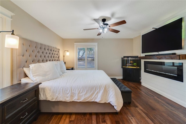 bedroom with dark hardwood / wood-style flooring and ceiling fan