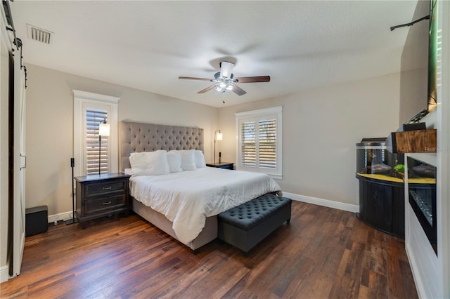 bedroom featuring ceiling fan and dark wood-type flooring