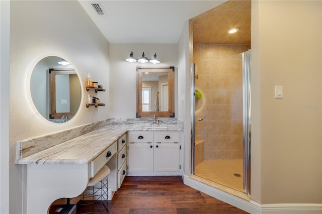 bathroom with vanity, wood-type flooring, and an enclosed shower