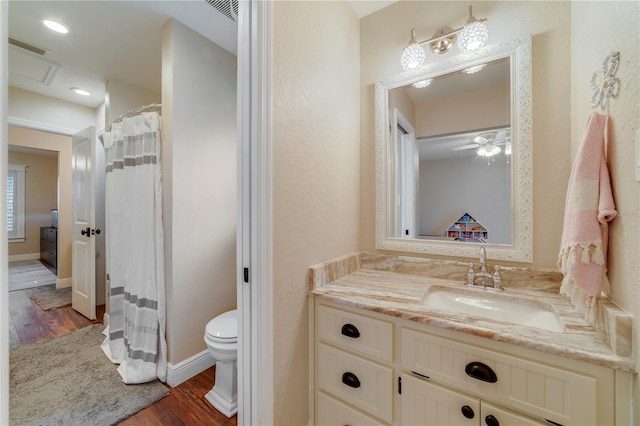 bathroom featuring vanity, ceiling fan, toilet, and wood-type flooring