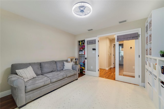 living room featuring french doors and hardwood / wood-style floors