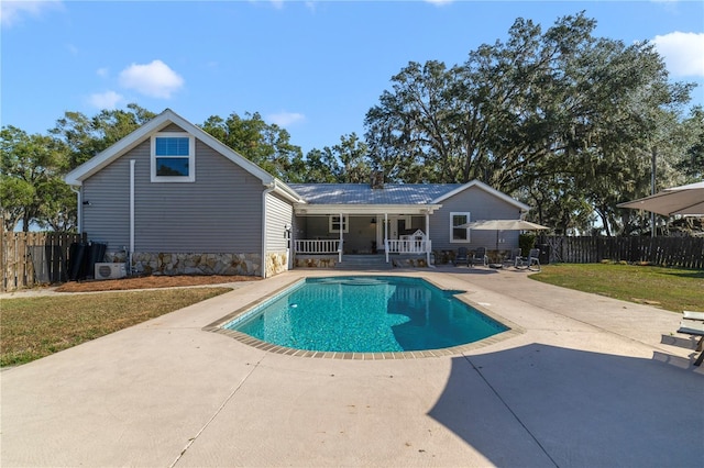 view of swimming pool featuring a yard and a patio