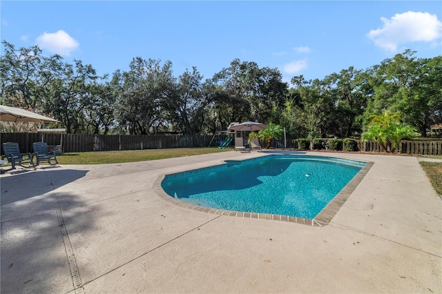 view of swimming pool with a yard and a patio