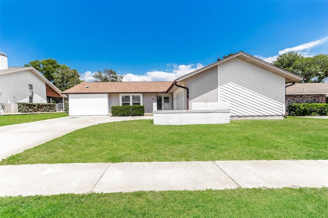 ranch-style house featuring a front yard and a garage