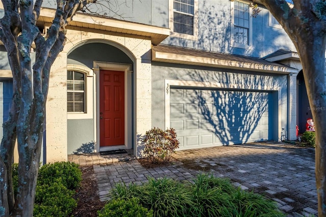 view of exterior entry featuring a garage