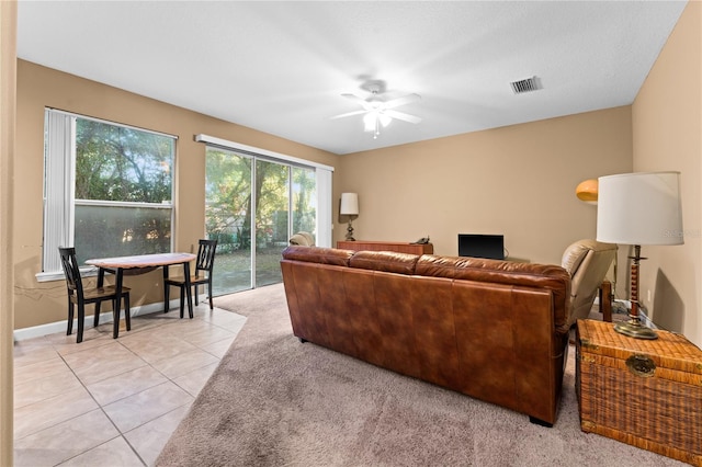 living room with ceiling fan and light tile patterned floors