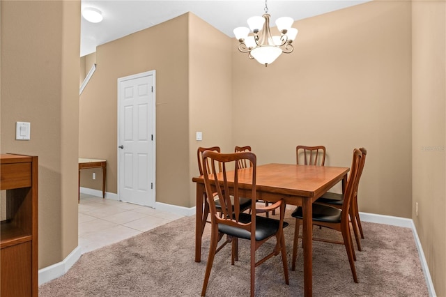 dining room featuring a notable chandelier and light colored carpet