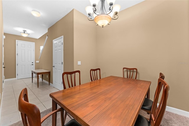 tiled dining space featuring a chandelier