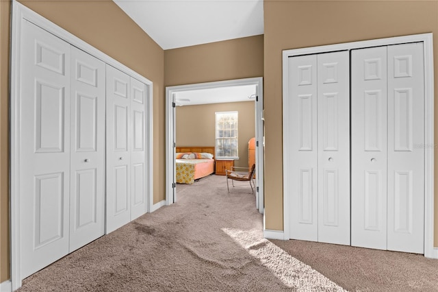 carpeted bedroom with two closets