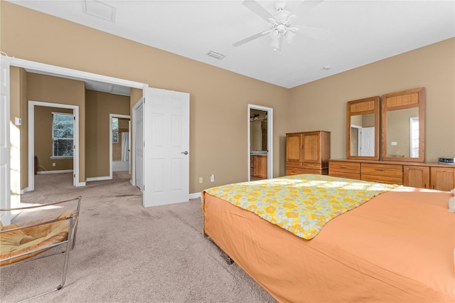 carpeted bedroom featuring ceiling fan and ensuite bathroom