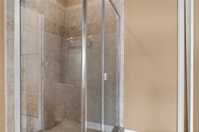 bathroom featuring a shower with door