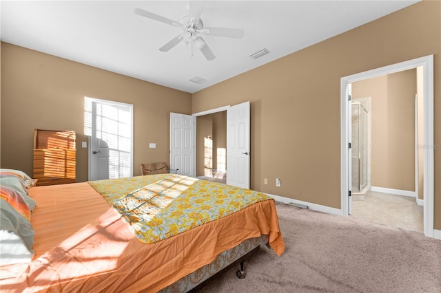 carpeted bedroom featuring connected bathroom and ceiling fan