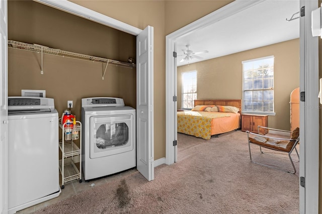 laundry area featuring ceiling fan, washing machine and dryer, and light carpet