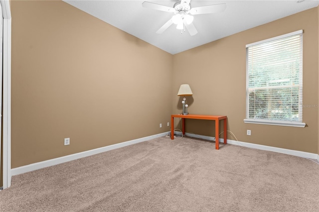 carpeted spare room with ceiling fan