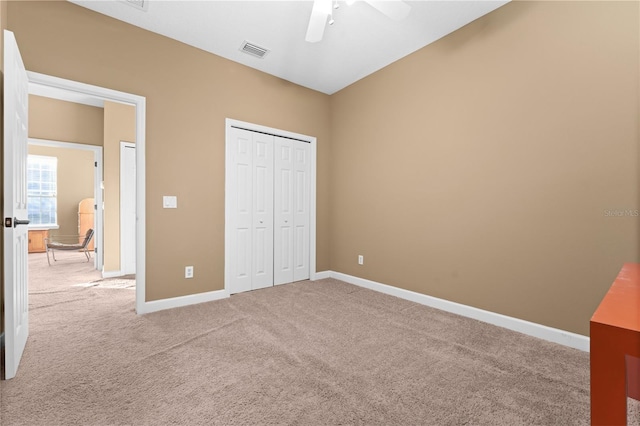 unfurnished bedroom featuring carpet flooring, a closet, and ceiling fan