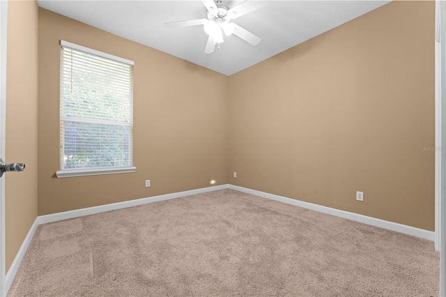 carpeted empty room featuring ceiling fan