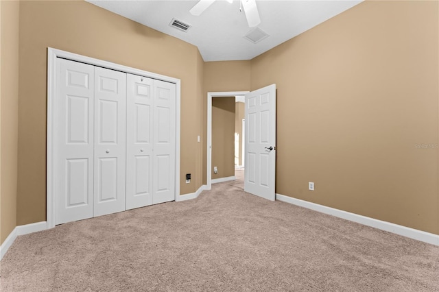 unfurnished bedroom with carpet flooring, ceiling fan, and a closet