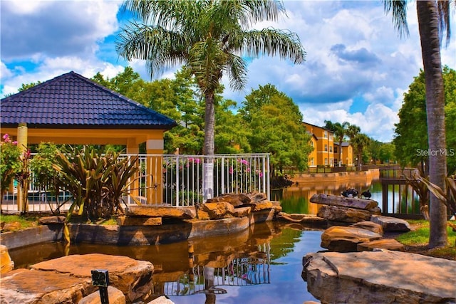 exterior space with a gazebo and a water view