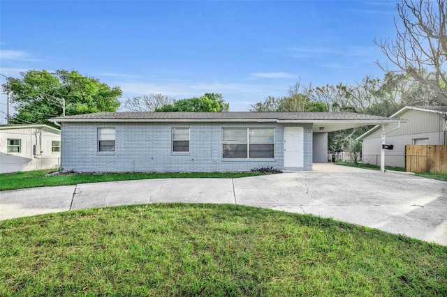 single story home with a front lawn and a carport