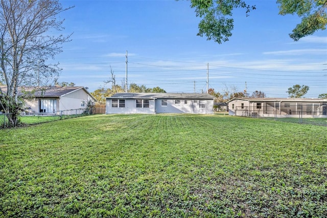 back of property featuring a lawn