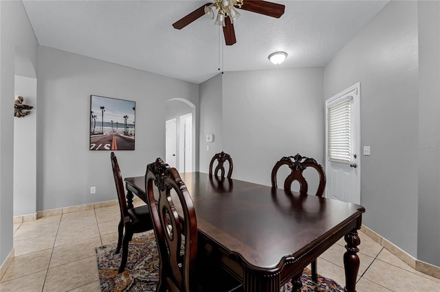 dining space featuring ceiling fan, light tile patterned floors, and a textured ceiling