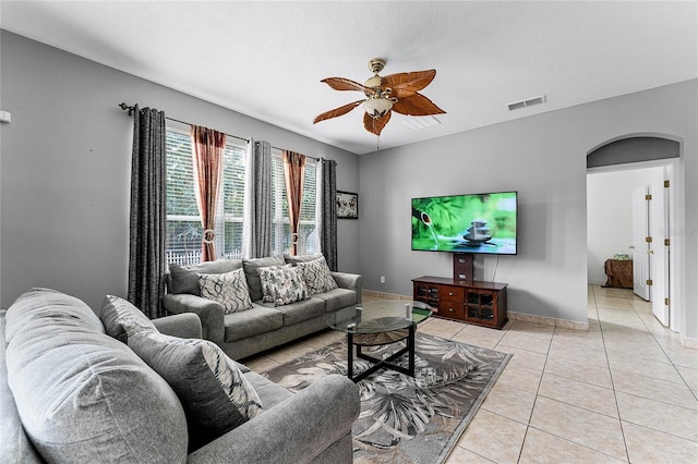 tiled living room with ceiling fan